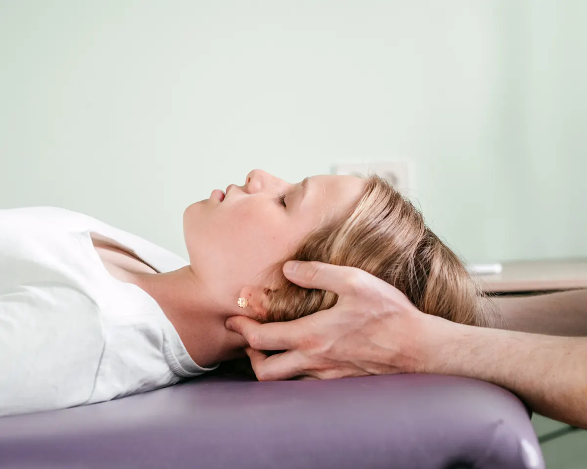 Mobile osteopath treating a patient in their home with a portable treatment table