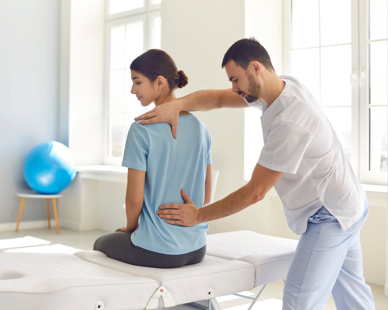 Osteopath performing spinal and postural assessment on a patient at Fix Mi Osteo Brampton